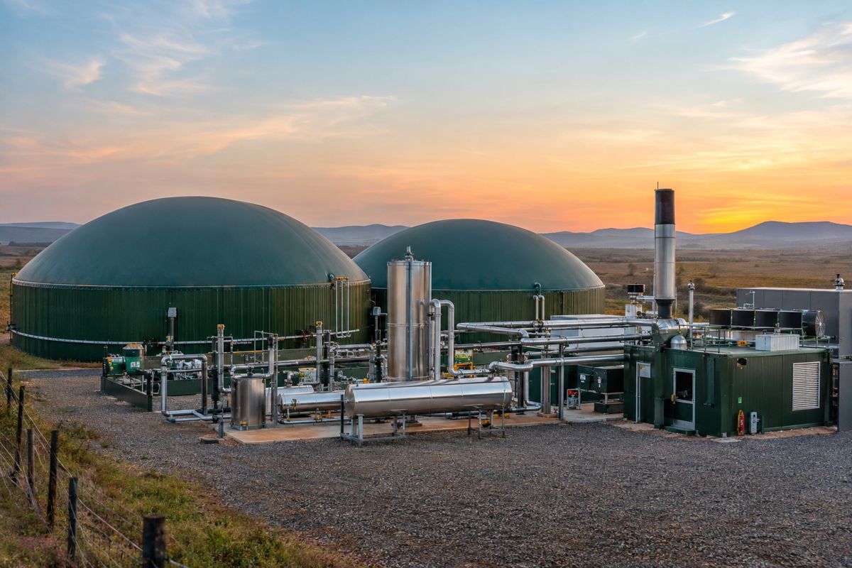 Waste-to-energy biogas digesters at dusk